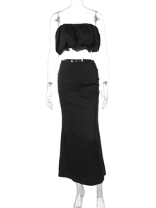 Detail of off-shoulder ruched top and high-waist bodycon maxi skirt in black