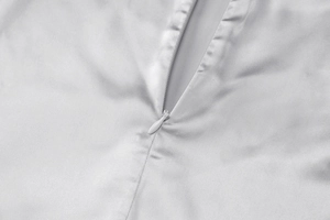 Detail of the high-quality invisible zipper on the sleek grey formal suit fabric