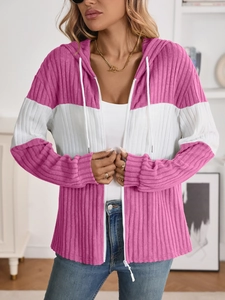 Close-up of pink and white ribbed knit texture on a hooded zip-up cardigan sweater