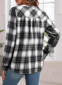 Rear view detail of black and white plaid shirt showing back pleats and fabric texture