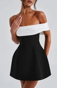 Detail view of monochrome off-shoulder mini dress with white crossover pleated neckline