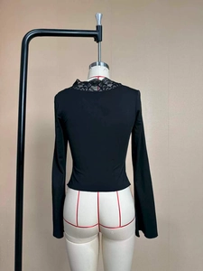 Detail view of the elegant lace trim on the V-neck and the slim fit design from the back
