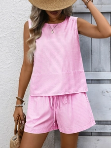 Detailed texture of pink and white striped sleeveless top and elastic waist summer shorts
