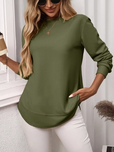 Close-up of army green waffle knit texture and ribbed cuffs on a casual long sleeve top