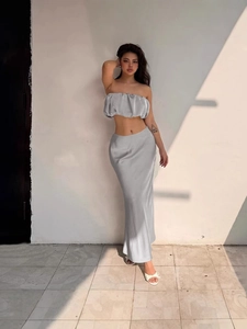Women's chic grey off-shoulder top and sleek satin maxi skirt two-piece set