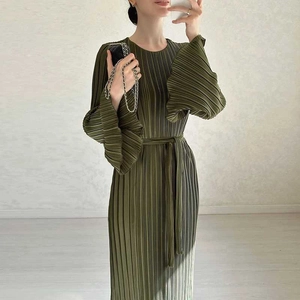 Detail view of olive green pleated maxi dress with flared ruffle cuffs and a slim waist belt