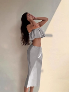 Silver-grey satin two-piece set featuring a cropped tube top and high-waist midi skirt
