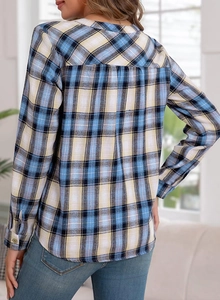 Detail of blue plaid shirt featuring back pleat design and casual long sleeves