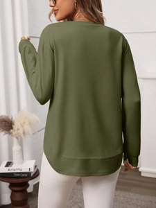 Detail of army green waffle knit sweater featuring a curved hem and ribbed cuffs on the back