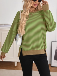 Detail of green and brown striped knit sweater with ribbed cuffs and side slit hemline