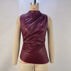 Detailed view of burgundy PU leather sleeveless top with asymmetric pleated design