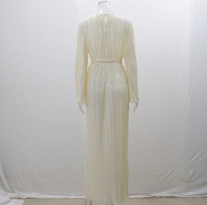 Detailed back view of a white pleated long sleeve maxi dress with waist tie and round neck