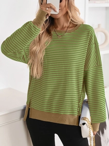 Detail view of green and brown striped knit sweater with side slits and ribbed cuffs