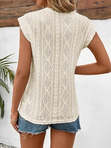 Detailed back view of cream sleeveless knit top featuring intricate hollow crochet patterns