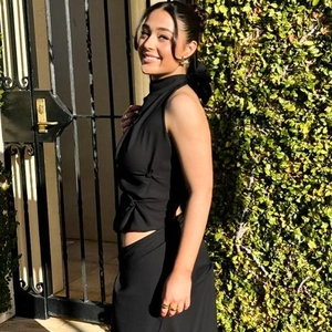Close-up of black halter neck crop top with backless tie detail and side ruching
