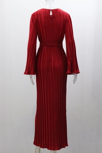 Detail of red pleated long dress showing vertical pleats and back neck button closure