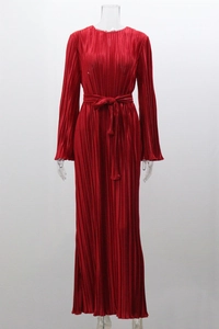 Detail view of red pleated maxi dress featuring a high neck and waist tie ribbon design