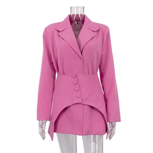 Detailed view of pink blazer dress with irregular curved hem and matching buttons