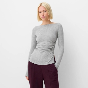 Detail of ruched waist design on a heather gray off-shoulder slim fit long sleeve top