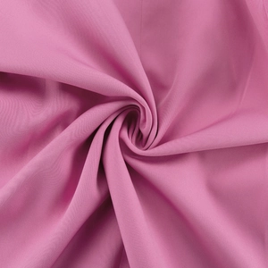Detailed view of pink textile fabric with soft texture and elegant draping quality