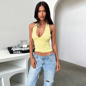 Detail shot of a slim fit light yellow halter neck top with a deep V-neckline