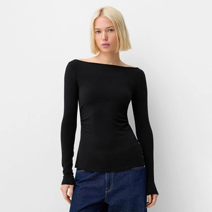 Detail of elegant black off-shoulder top featuring side ruched waist and slim fit design