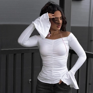Detail of white off-shoulder top featuring ruched front and elegant bell flared sleeves