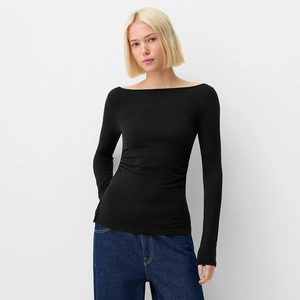 Detail of elegant black off-shoulder long sleeve top with slim fit and fine knit texture