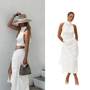 Detail showing the white wrap halter top and matching ruched skirt with knot detail
