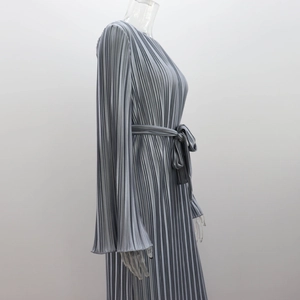 Detailed view of silver pleated dress featuring silky texture and tie-waist design