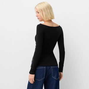 Detail of boat neck design and slim fit back profile on black long sleeve T-shirt