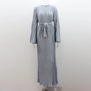 Detail of light blue pleated maxi dress showing fine vertical texture and waist tie belt