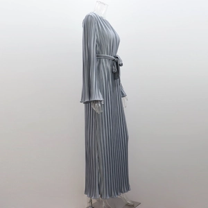 Detail of light gray plissé long sleeve dress showing pleated texture and matching waist tie