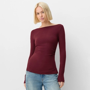 Detail of the side ruching and texture on a burgundy boat neck slim-fit long-sleeve top