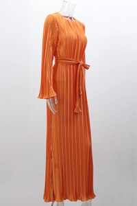 Detail view of orange pleated maxi dress with vertical pleats and matching slim belt