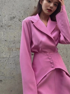 Pink two-piece suit with lapel blazer and high-waist mini skirt with decorative buttons