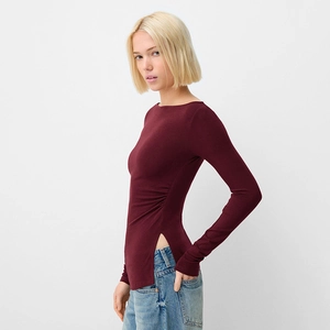 Close-up of slim fit burgundy off-shoulder top with side slit and ribbed texture