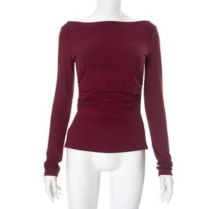 Detail view of the elegant off-shoulder neckline and ruched waist on wine red top