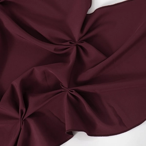 Detail shot of the burgundy chiffon fabric showing fine rolled hem and soft pleated texture
