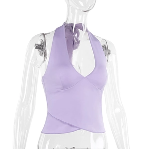 Detail view of light purple halter neck top featuring a criss-cross hem and slim fit