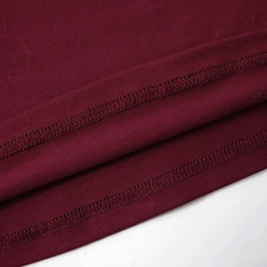 Macro view showing double-needle stitched hem and knit texture of burgundy top