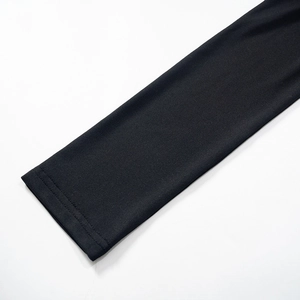 Close-up of the double-needle flat stitching on the cuff of a black long-sleeved bodysuit