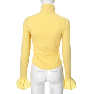 Detail of flared ruffled cuffs on a slim-fit bright yellow knit top shown from back view