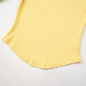Detail view of light yellow ribbed knit top featuring a curved hemline and fine stitching