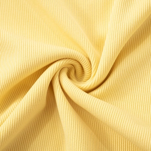 Detailed macro view of soft pale yellow ribbed knit fabric with vertical textures