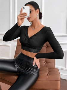 Slim fit black V-neck long sleeve knit crop top with ruching and lace hem trim detail