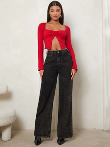 Slim fit red long sleeve crop top with ruched cutout neckline and wide leg denim jeans