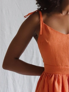 Detail view of cotton-linen blend fabric with adjustable shoulder straps and waist tie