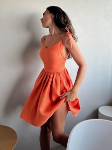 Sleeveless orange cotton mini dress with tie straps and high waist flared skirt for summer