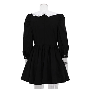 Detail view of the black French dress back with white ruffle collar and A-line pleated skirt